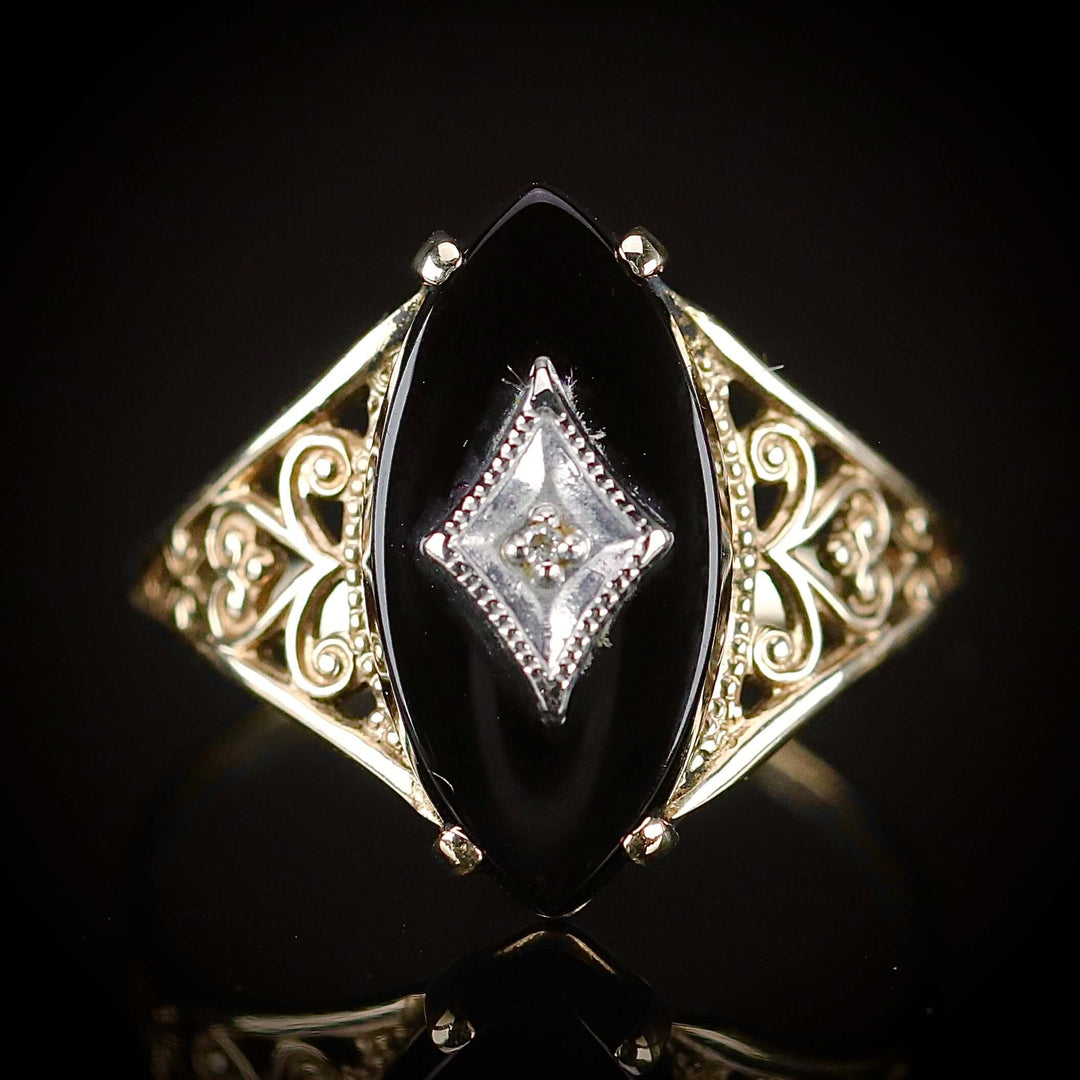 Vintage navette onyx and diamond ring in yellow gold