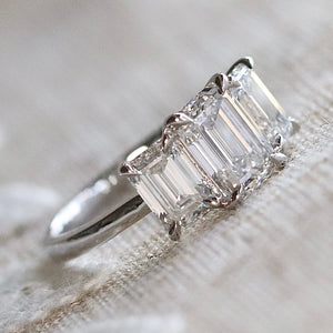 MANOR ROYAL:  The Charlotte - 3 stone 3.03ctw lab grown emerald cut diamond ring in platinum