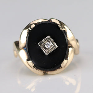 Vintage oval onyx and diamond ring in yellow gold