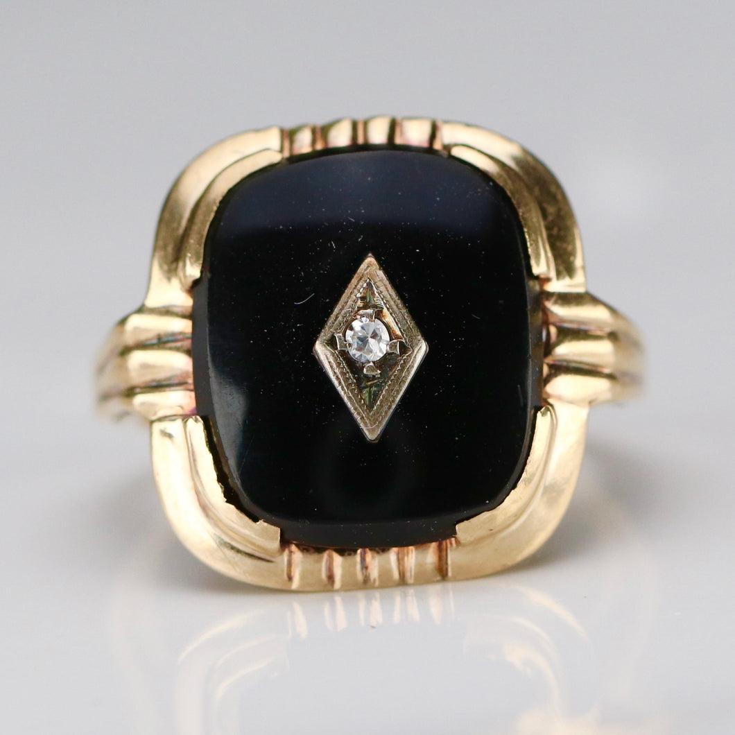 Vintage cushion cut onyx and diamond ring in yellow gold