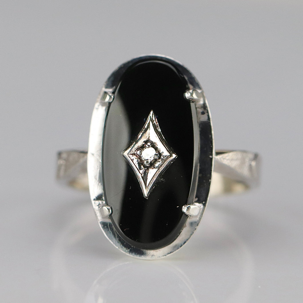 Oval onyx and diamond vintage ring in white gold from Manor Jewels.