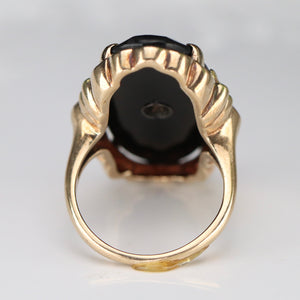 Large oval vintage black onyx and diamond ring in rose, green, and yellow gold ring