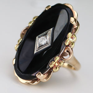 Large oval vintage black onyx and diamond ring in rose, green, and yellow gold ring