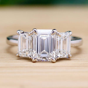 MANOR ROYAL:  The Charlotte - 3 stone 3.03ctw lab grown emerald cut diamond ring in platinum