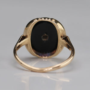 Vintage oval onyx and diamond ring in yellow gold