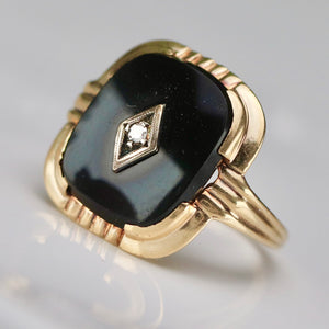 Vintage cushion cut onyx and diamond ring in yellow gold