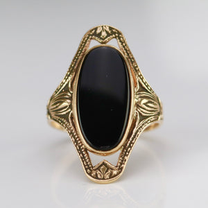 Classic onyx ring in a framed setting of yellow gold