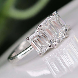 MANOR ROYAL:  The Charlotte - 3 stone 3.03ctw lab grown emerald cut diamond ring in platinum