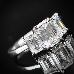 MANOR ROYAL:  The Charlotte - 3 stone 3.03ctw lab grown emerald cut diamond ring in platinum