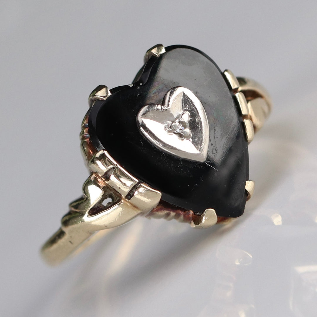 Heart shaped onyx and diamond ring in yellow gold