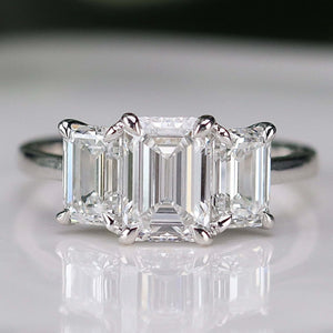 MANOR ROYAL:  The Charlotte - 3 stone 3.03ctw lab grown emerald cut diamond ring in platinum