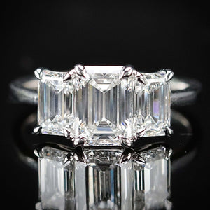 MANOR ROYAL:  The Charlotte - 3 stone 3.03ctw lab grown emerald cut diamond ring in platinum