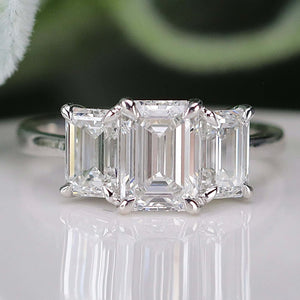 MANOR ROYAL:  The Charlotte - 3 stone 3.03ctw lab grown emerald cut diamond ring in platinum