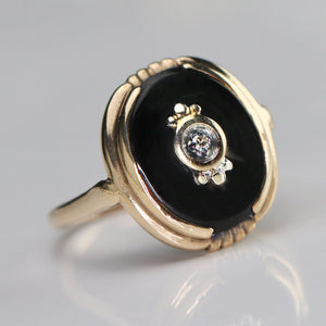 Vintage oval onyx and diamond ring in yellow gold